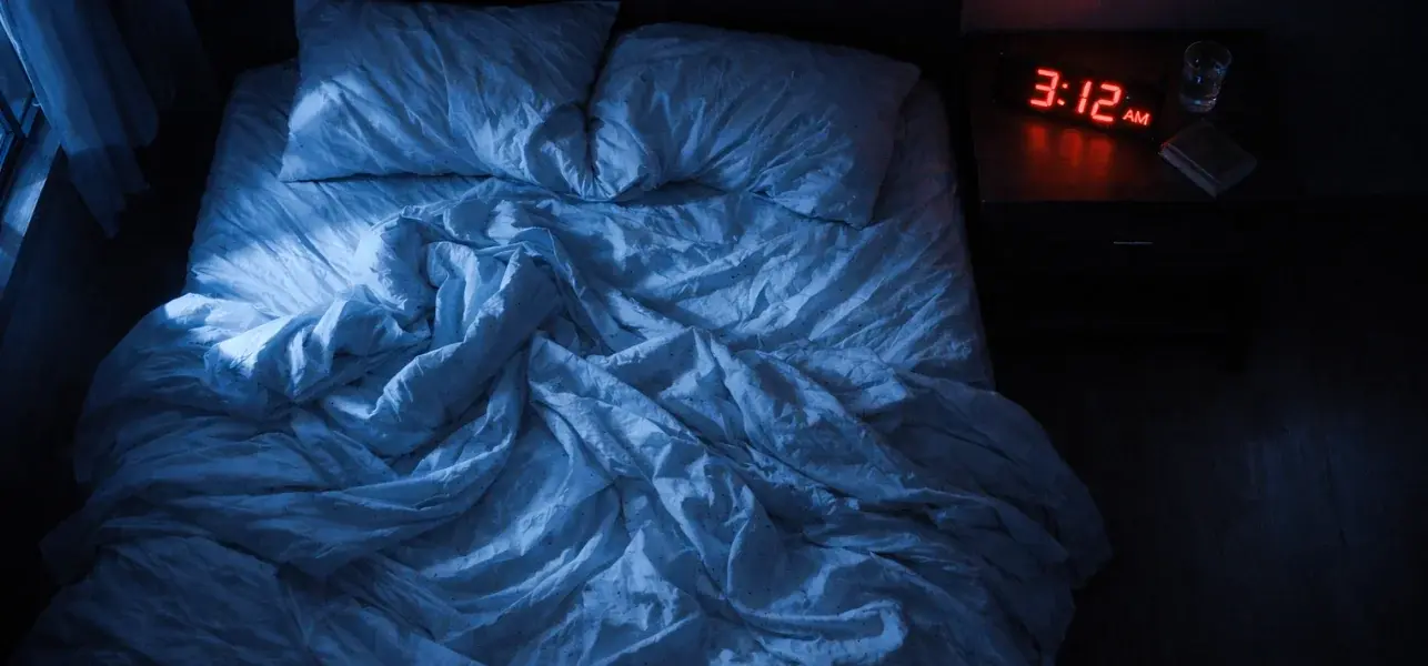 Empty messy bed at 3:12 AM